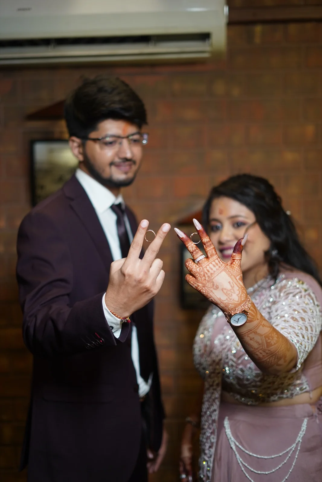 Aishwarye and Anmol holding up their rings